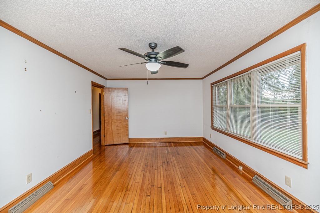 406 McFarland Road Broadway, NC 27505 - Photo 5 of 37 a view of empty room with wooden floor and fan