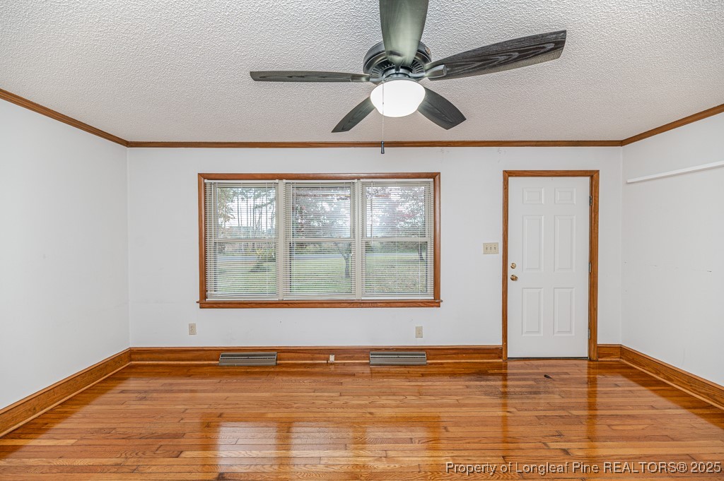 406 McFarland Road Broadway, NC 27505 - Photo 6 of 37 a view of an empty room with wooden floor and a window