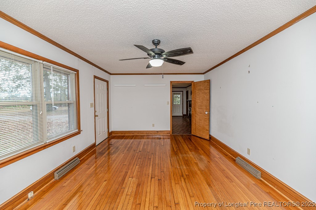 406 McFarland Road Broadway, NC 27505 - Photo 7 of 37 a view of empty room with wooden floor and fan