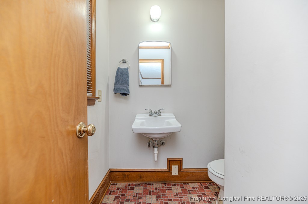 406 McFarland Road Broadway, NC 27505 - Photo 10 of 37 a bathroom with a sink a light fixture and a mirror