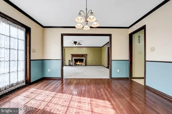 a kitchen with stainless steel appliances granite countertop a refrigerator a sink dishwasher a stove with wooden cabinets and floor