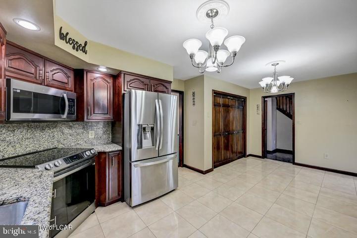1424 East Broad Street Hazleton, PA 18201 - Photo 25 of 89 a kitchen with stainless steel appliances granite countertop a refrigerator oven a sink dishwasher a dining table and chairs with wooden floor