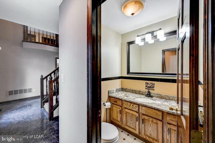 1424 East Broad Street Hazleton, PA 18201 - Photo 32 of 89 a bathroom with a granite countertop sink and a mirror