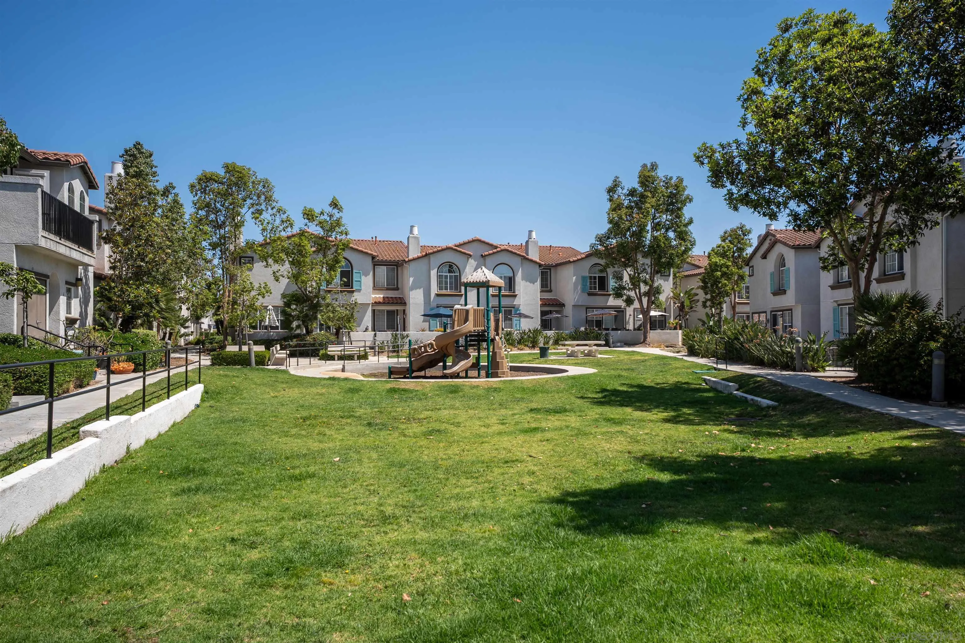 289 Reef Point Way, Unit 3 Oceanside, CA 92058 - Photo 21 of 23 a front view of a house with a yard