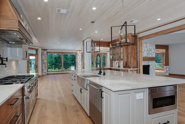 a stove top oven sitting inside of a kitchen