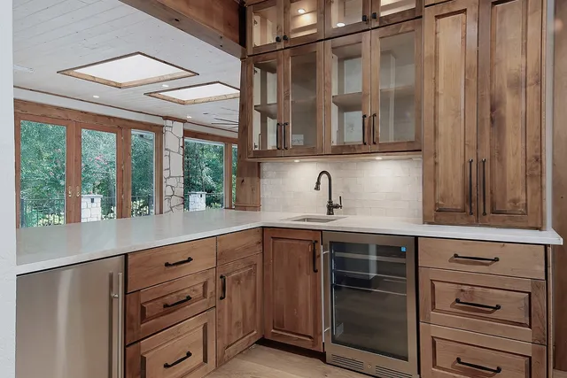 a kitchen with sink stove and refrigerator