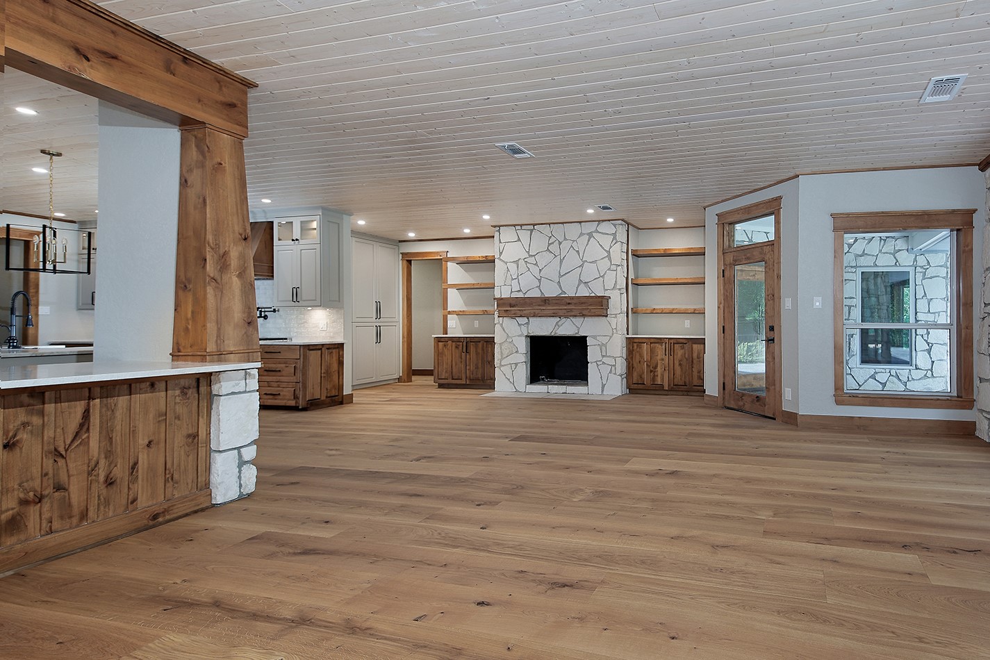 26442 McDonald Road Spring, TX 77380 - Photo 17 of 43 an empty room with wooden floor and fireplace