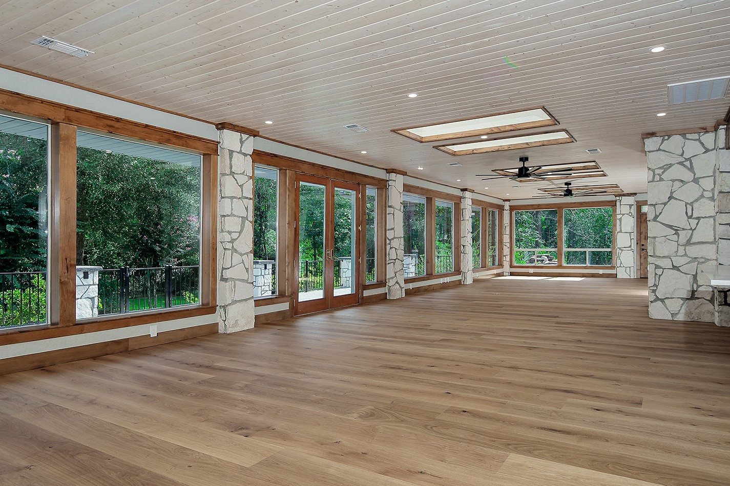 26442 McDonald Road Spring, TX 77380 - Photo 19 of 43 a view of an empty room with wooden floor and a floor to ceiling window