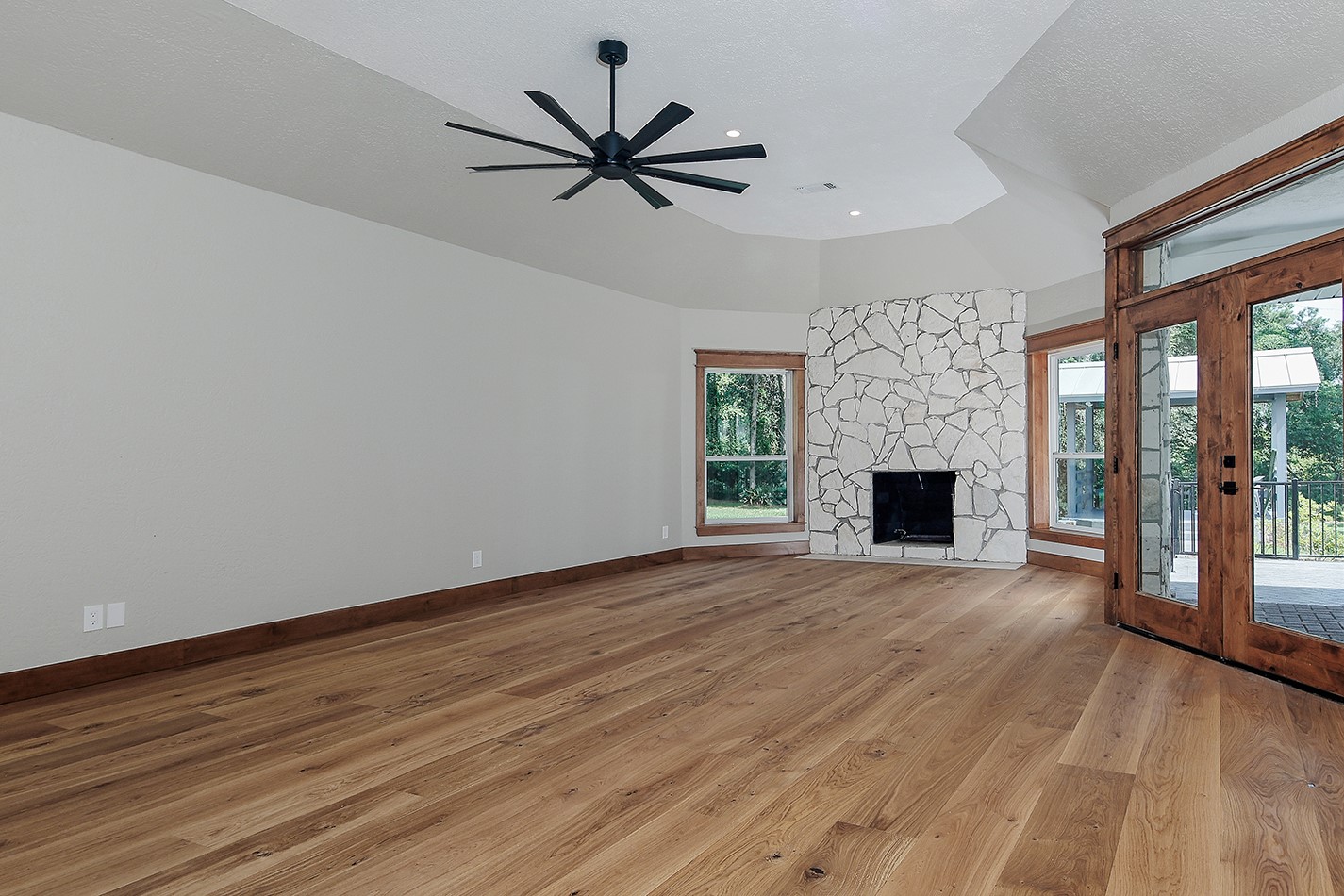 26442 McDonald Road Spring, TX 77380 - Photo 26 of 43 a view of empty room with wooden floor and fireplace