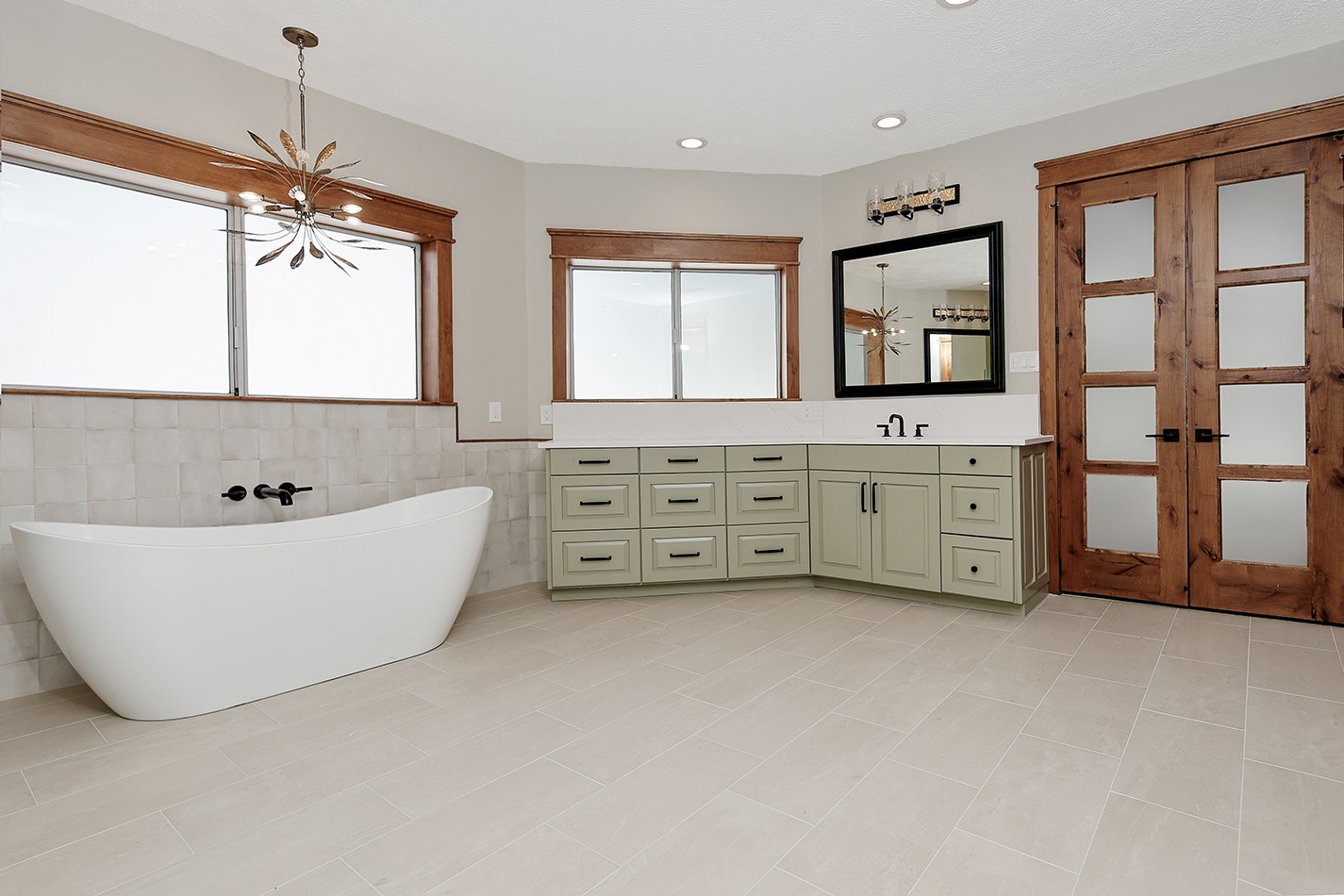 26442 McDonald Road Spring, TX 77380 - Photo 30 of 43 a spacious bathroom with windows bathtub and chandelier