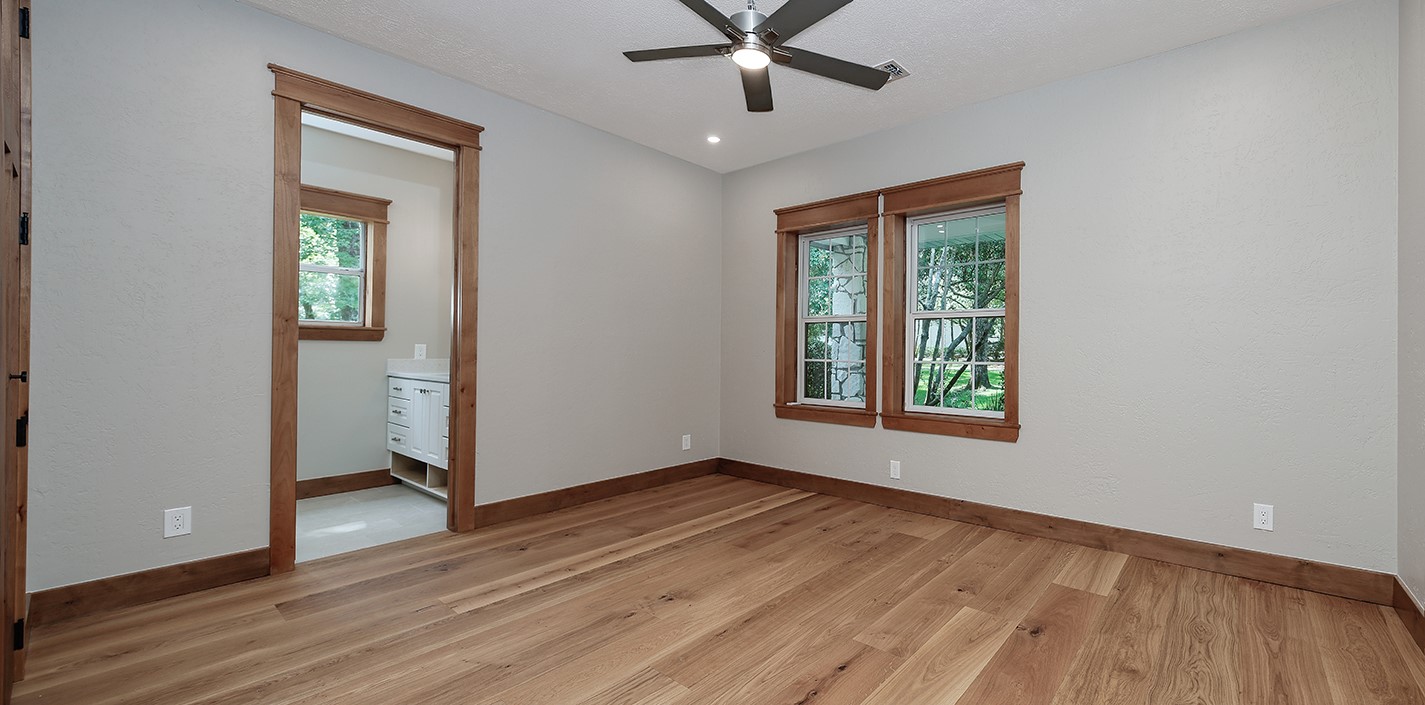 26442 McDonald Road Spring, TX 77380 - Photo 36 of 43 an empty room with wooden floor chandelier fan and windows