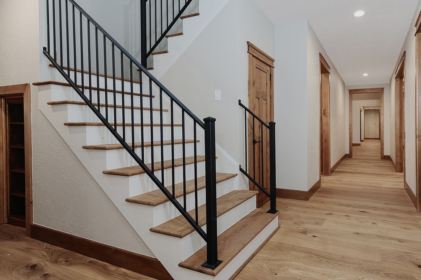 26442 McDonald Road Spring, TX 77380 - Photo 38 of 43 a view of staircase with lots of frames on wall and wooden floor