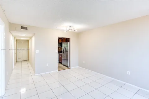 a kitchen with granite countertop a sink stove and cabinets