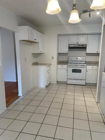 a kitchen with a stove a sink and a refrigerator