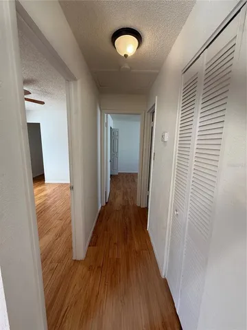 a view of a hallway with wooden floor