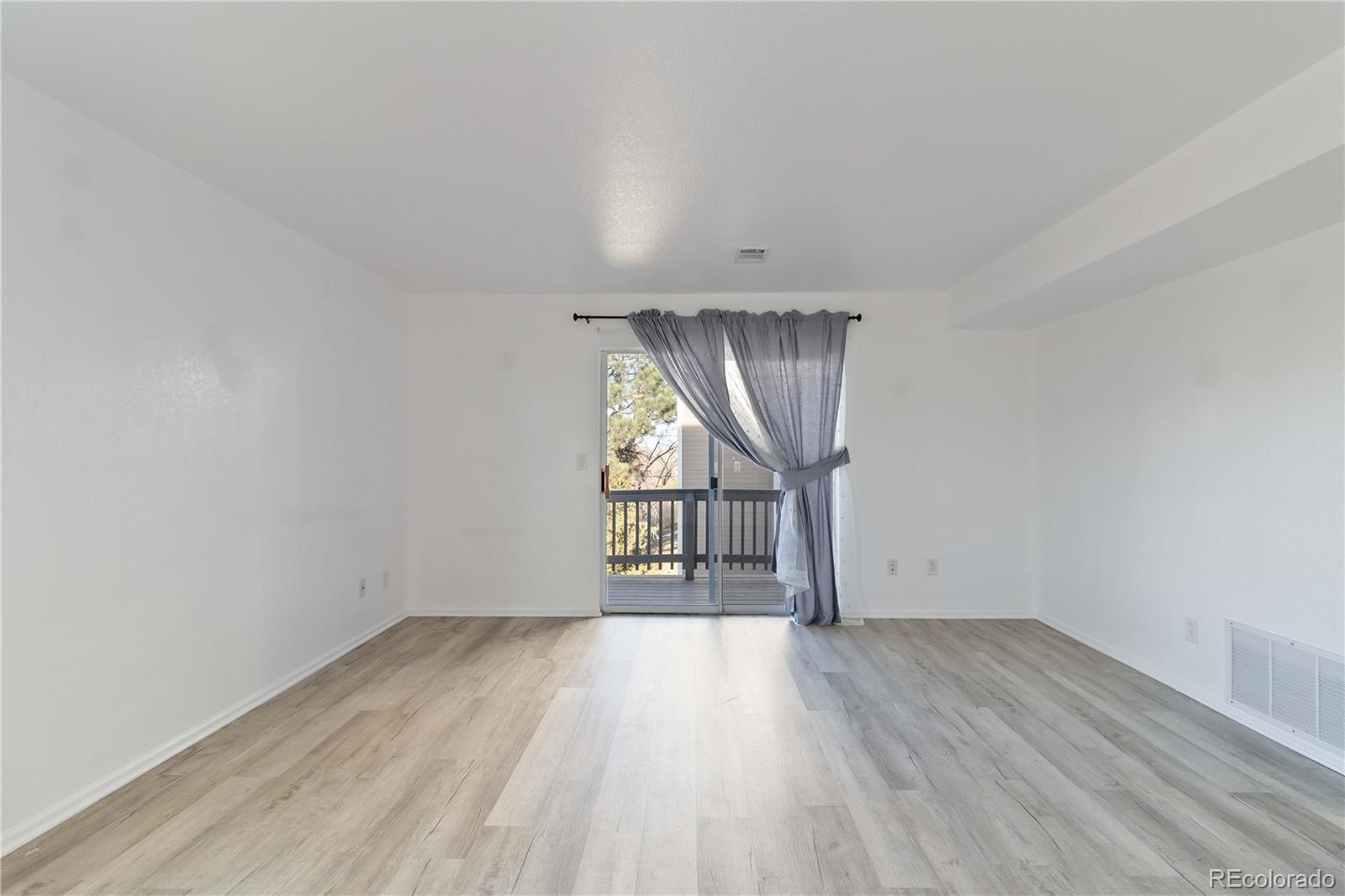 1263 South Gilbert Street, Unit B201 Castle Rock, CO 80104 - Photo 12 of 25 wooden floor in an empty room with a window