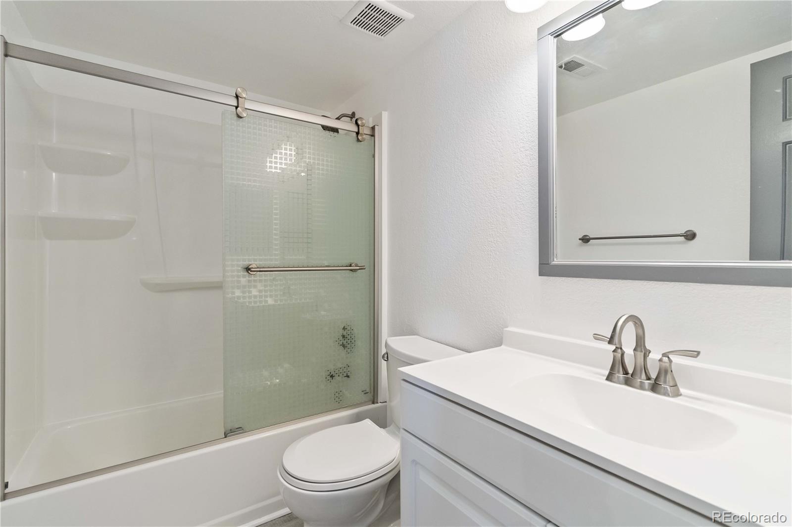 1263 South Gilbert Street, Unit B201 Castle Rock, CO 80104 - Photo 18 of 25 a bathroom with a granite countertop sink toilet and shower