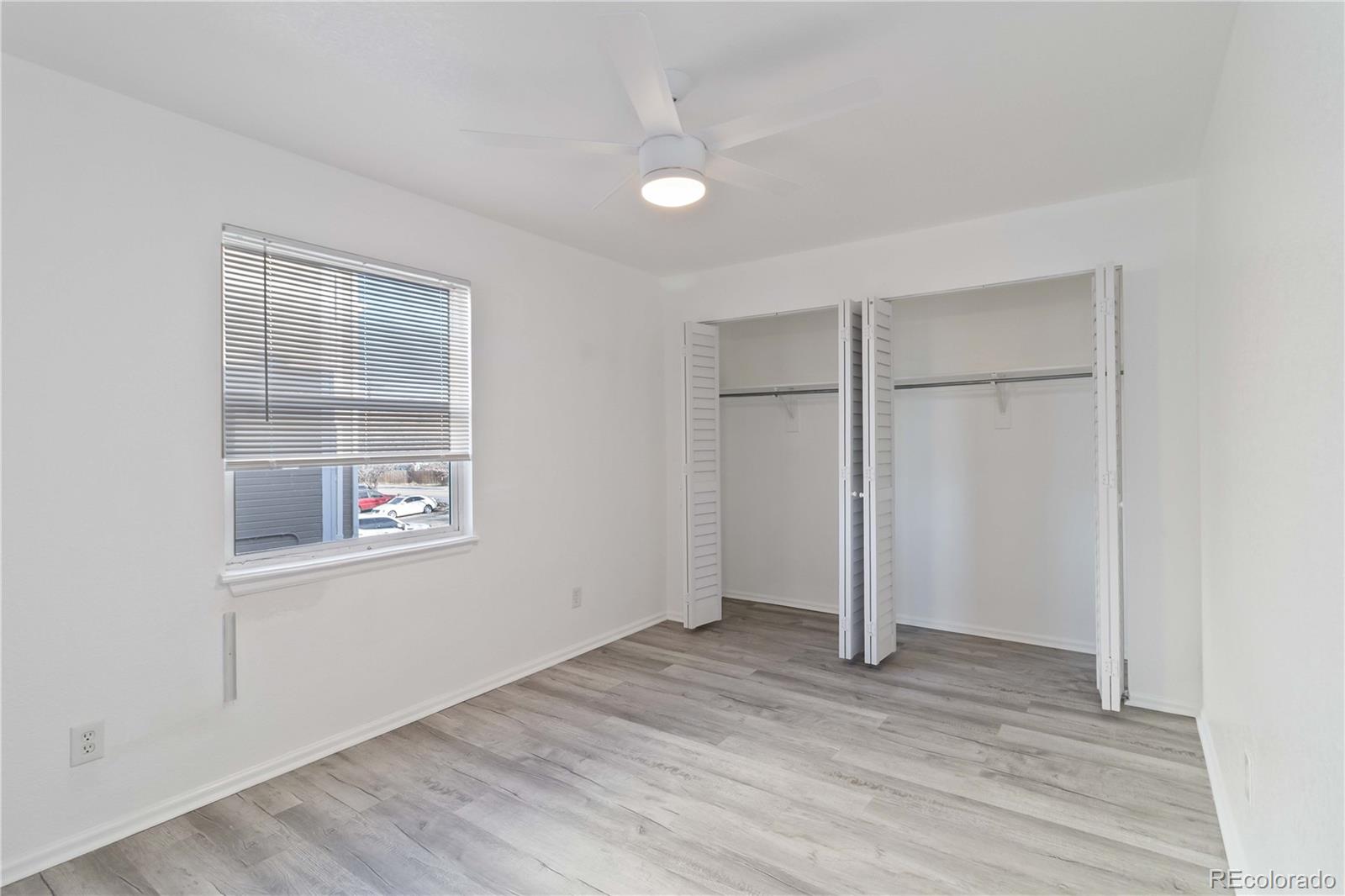 1263 South Gilbert Street, Unit B201 Castle Rock, CO 80104 - Photo 20 of 25 a view of an empty room with wooden floor and a window