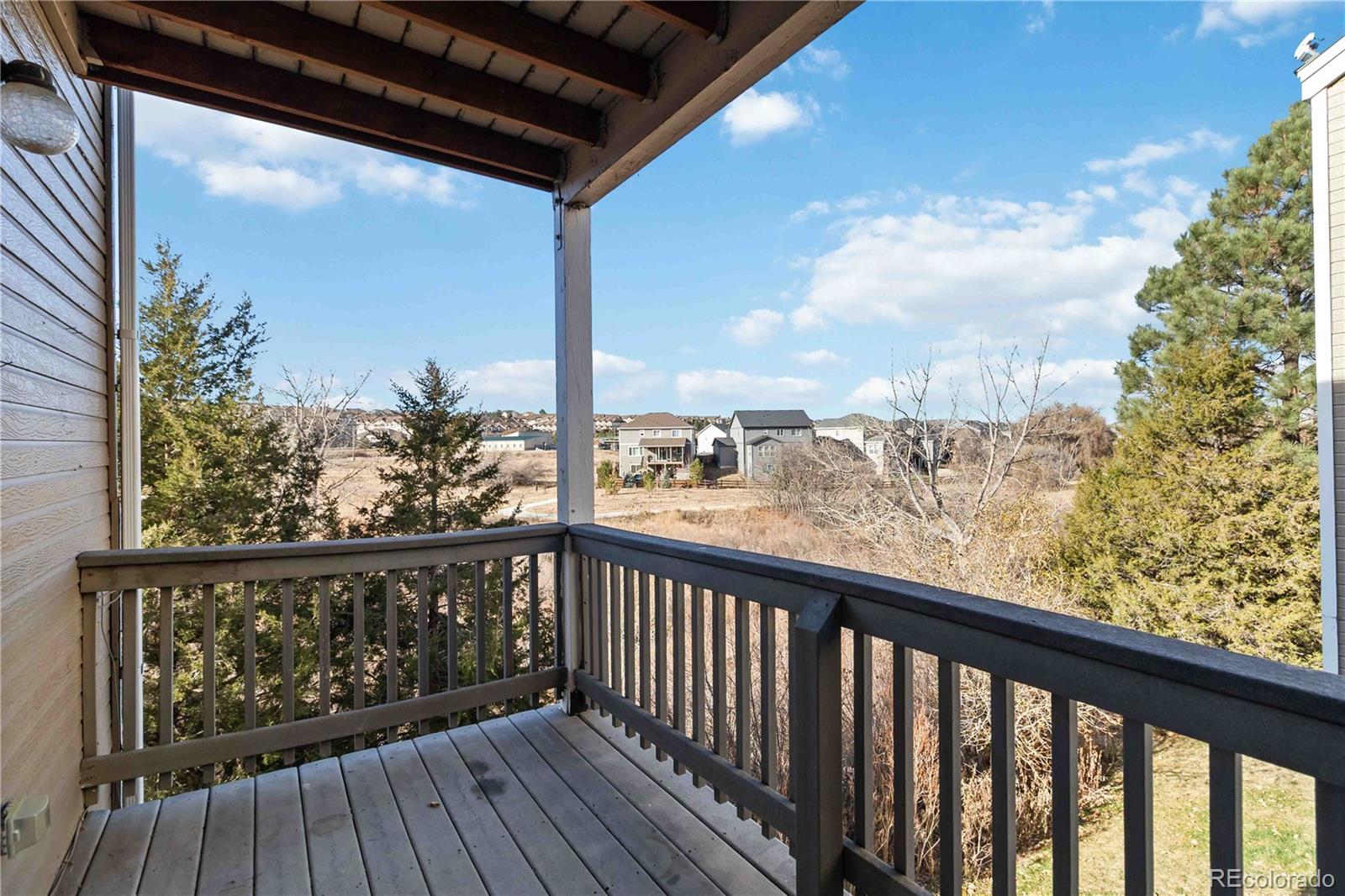 1263 South Gilbert Street, Unit B201 Castle Rock, CO 80104 - Photo 24 of 25 a view of a balcony with wooden floor