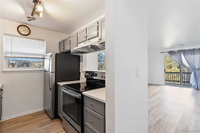 a kitchen with stainless steel appliances granite countertop a refrigerator and a stove