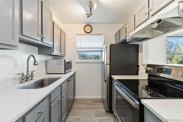a kitchen with stainless steel appliances granite countertop a refrigerator and a sink