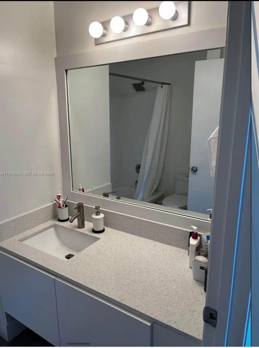15330 Southwest 106th Terrace, Unit 915 Miami, FL 33196 - Photo 5 of 8 a bathroom with a sink and a mirror