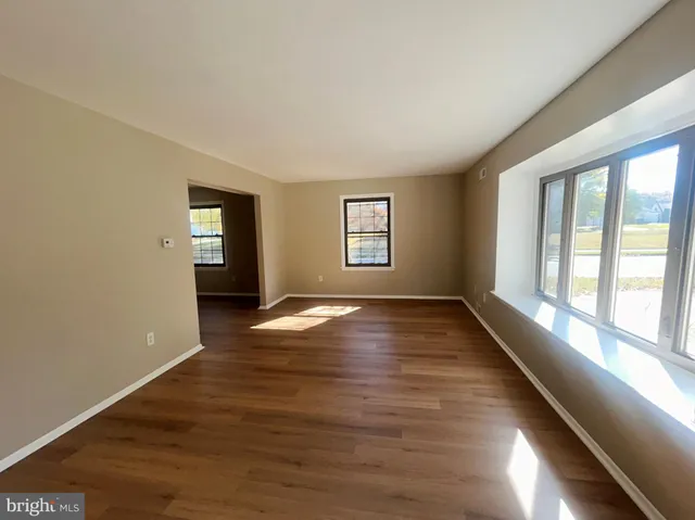 wooden floor in an empty room with a window