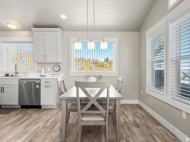 608 Fremont Road Fish Haven, ID 83287 - Photo 13 of 35 Open-concept dining area featuring wood-finish flooring, recessed lighting, and a vaulted ceiling