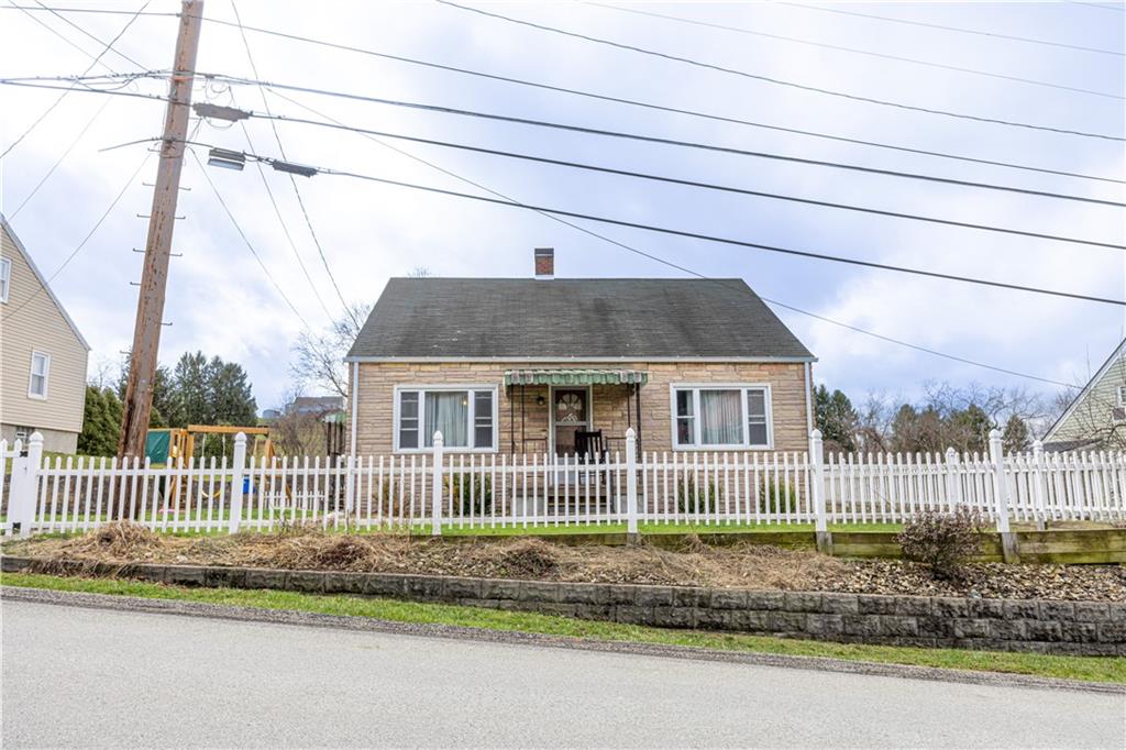 210 Stone Church Road Grindstone, PA 15442 - Photo 1 of 18 a front view of a house with a garden and plants