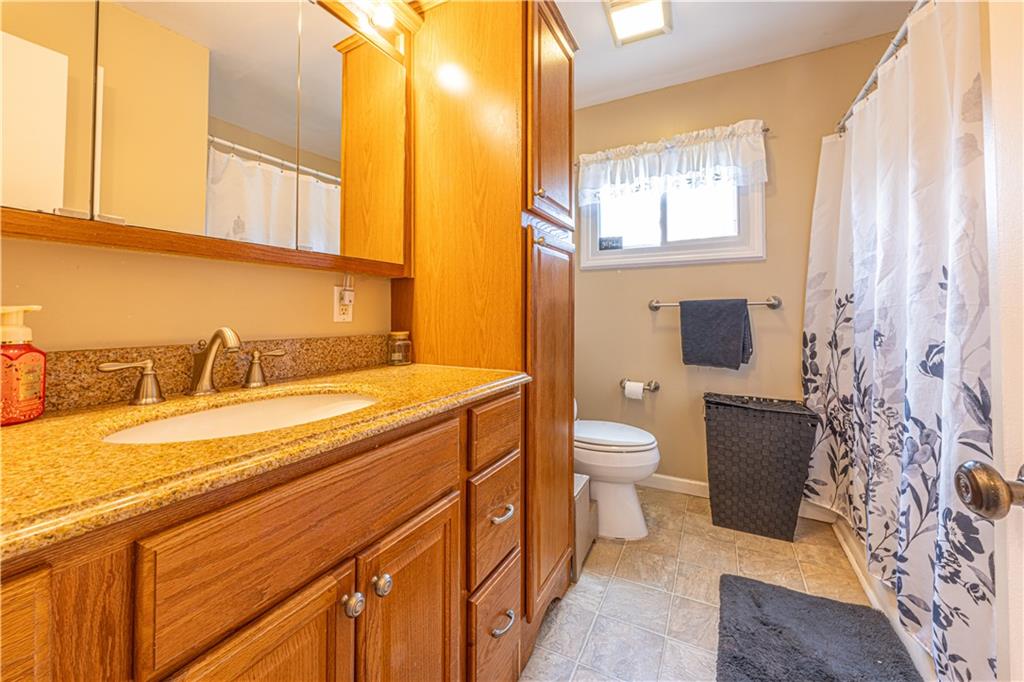 210 Stone Church Road Grindstone, PA 15442 - Photo 13 of 18 a bathroom with a granite countertop toilet sink and mirror