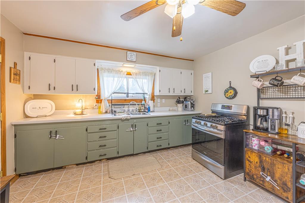 210 Stone Church Road Grindstone, PA 15442 - Photo 2 of 18 a kitchen with stainless steel appliances granite countertop a stove and a sink