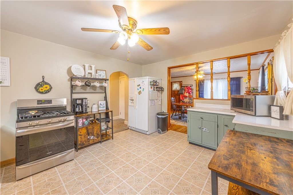 210 Stone Church Road Grindstone, PA 15442 - Photo 4 of 18 a kitchen with stainless steel appliances granite countertop a stove and a refrigerator