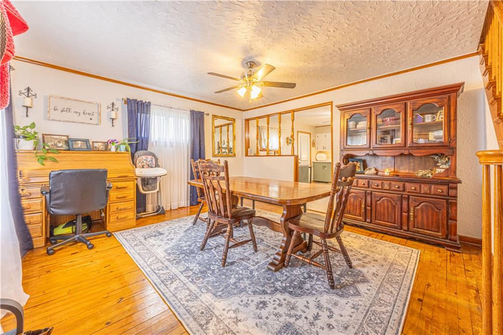 210 Stone Church Road Grindstone, PA 15442 - Photo 7 of 18 a dining room with wooden floor and a dining table