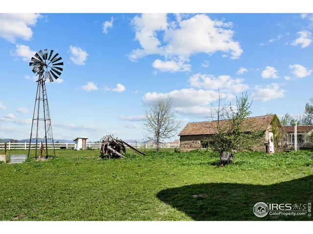 a view of a big house with a big yard and potted plants