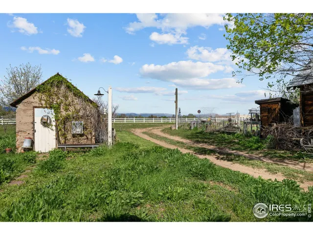 a backyard of a house with lots of green space and lake view