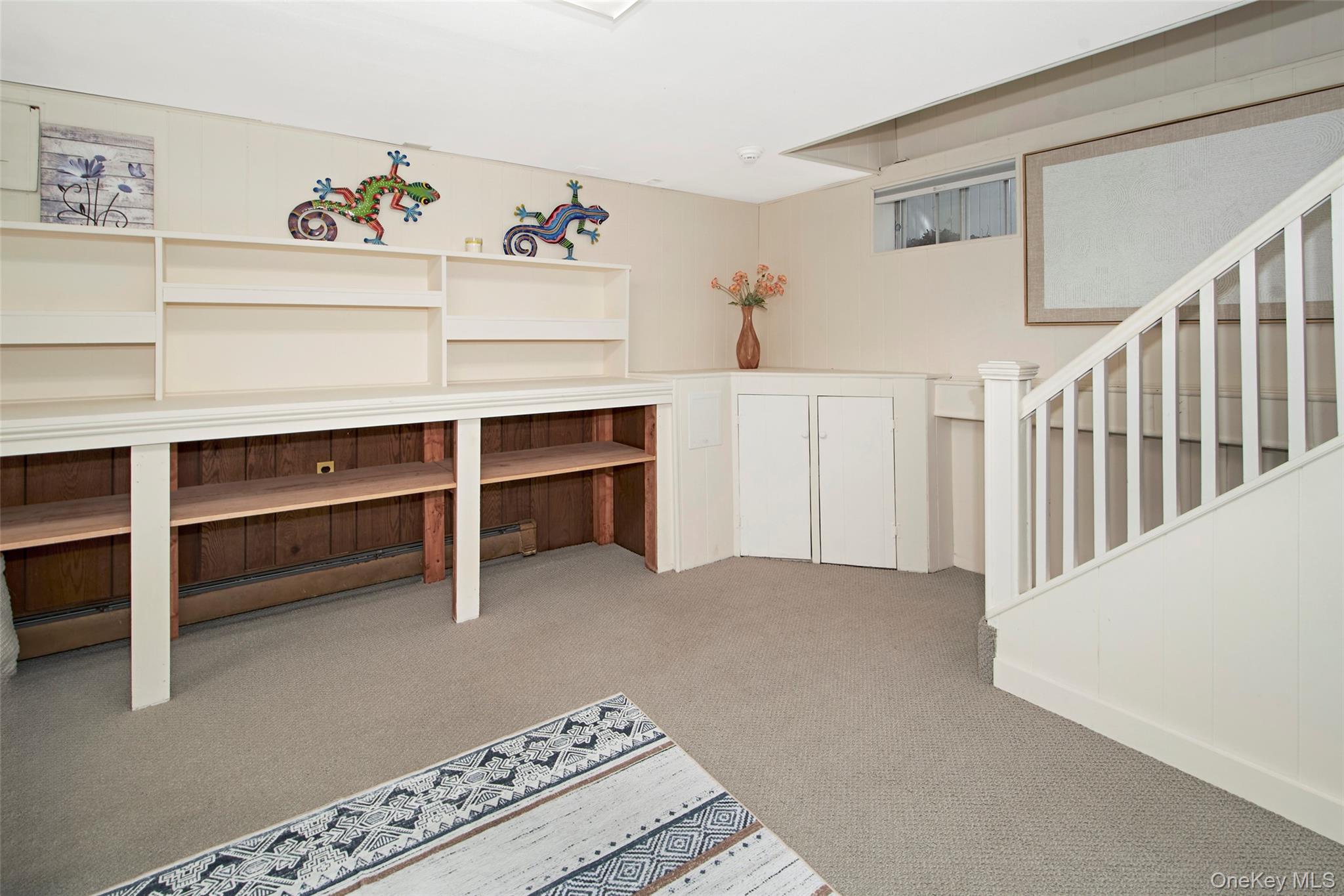 9 Fenton Street Rye, NY 10580 - Photo 19 of 22 A thoughtfully finished lower level providing flexible bonus living space for recreation, media, fitness, remote work, or creative pursuits. Complemented by a full bathroom with a walk-in shower, built-in storage, and open space, this level offers exceptional versatility and enhances the home's overall comfort and functionality.