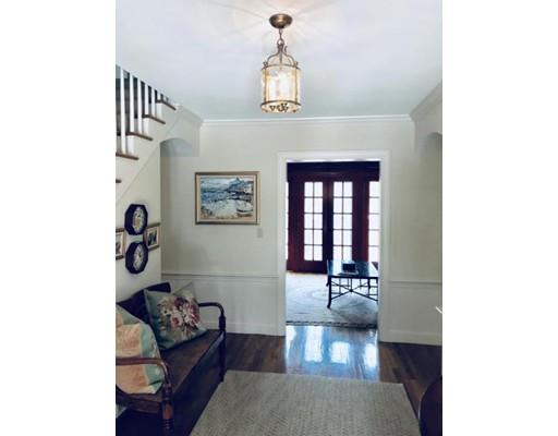 390 Eel River Road Barnstable, MA 02655 - Photo 4 of 27 a hallway with couches and a dining table with wooden floor
