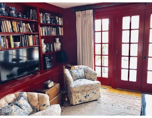 390 Eel River Road Barnstable, MA 02655 - Photo 5 of 27 a living room with furniture and a flat screen tv and a book shelf