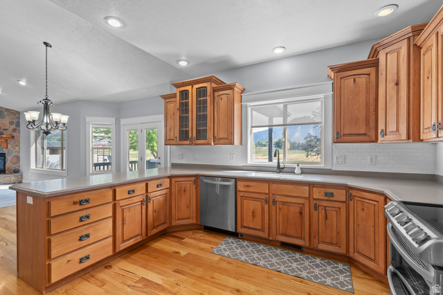 1501 West Elk Circle Mapleton, UT 84664 - Photo 19 of 39 Spacious kitchen featuring light wood cabinetry with display uppers, stainless steel appliances, and a light-toned countertop