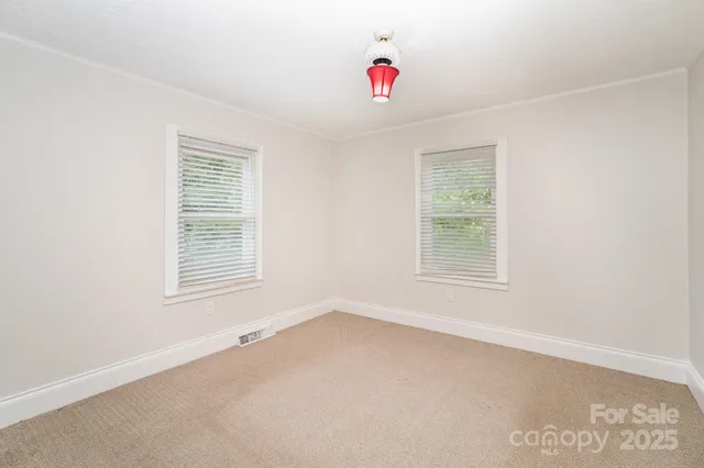 a bedroom with a bed and a potted plant