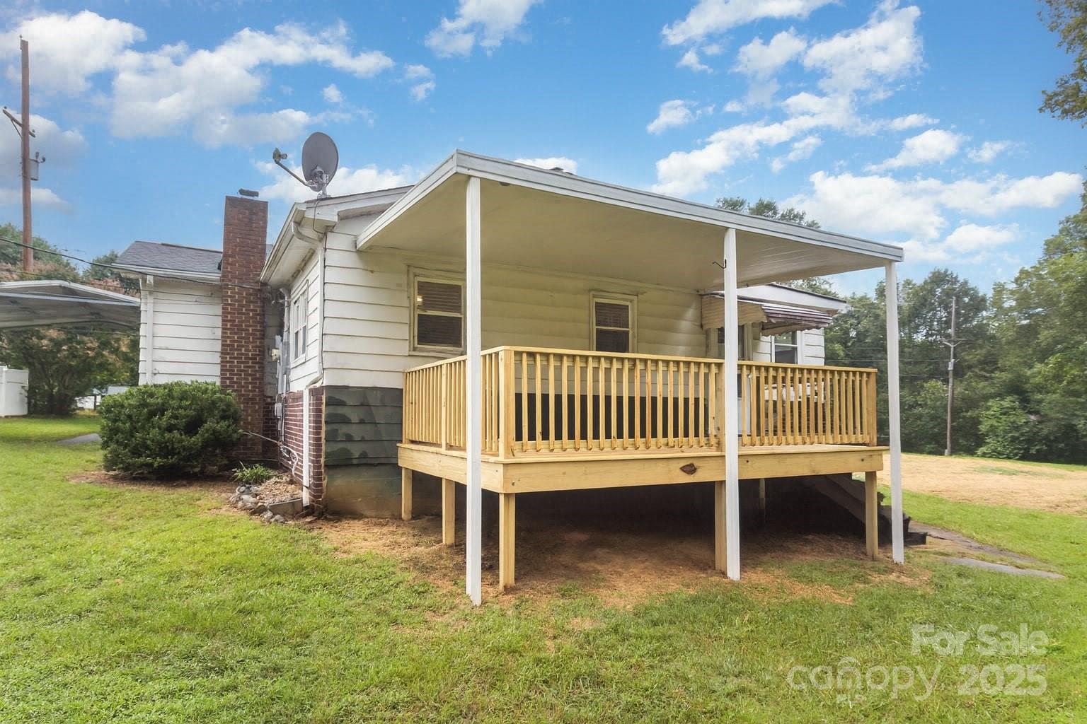 264 Mauney Farm Road Cherryville, NC 28021 - Photo 23 of 25 a view of a house with a backyard and deck