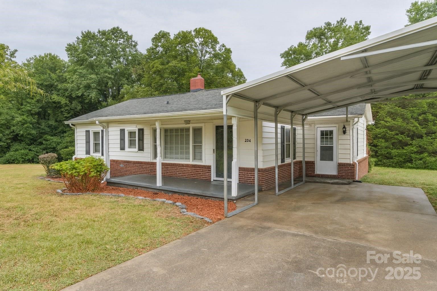264 Mauney Farm Road Cherryville, NC 28021 - Photo 25 of 25 a view of a house with a backyard and a large tree