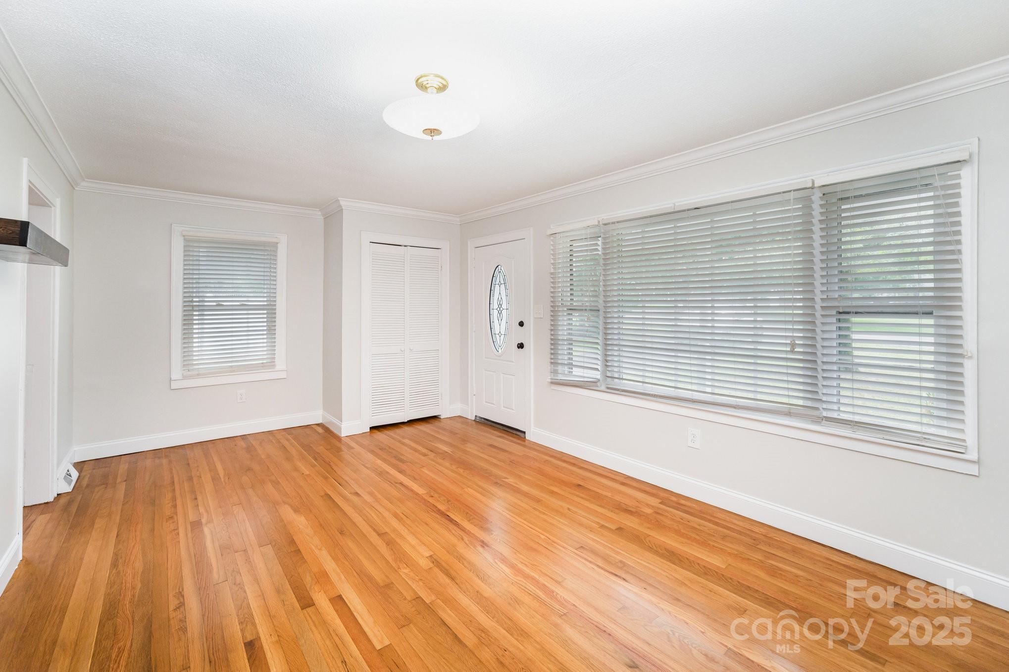 264 Mauney Farm Road Cherryville, NC 28021 - Photo 5 of 25 a view of an empty room with wooden floor and a window