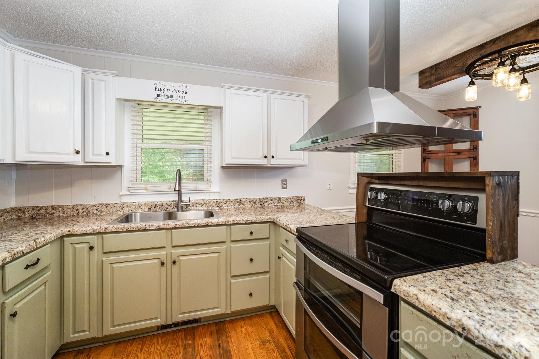 264 Mauney Farm Road Cherryville, NC 28021 - Photo 10 of 25 a kitchen with granite countertop a stove sink and cabinets