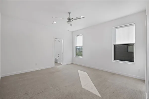 a view of an empty room with a ceiling fan