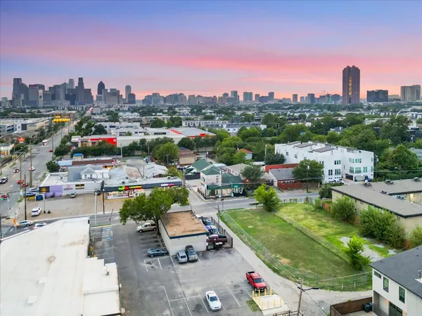 an aerial view of residential houses with city view