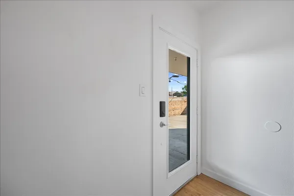 a view of a hallway with wooden floor