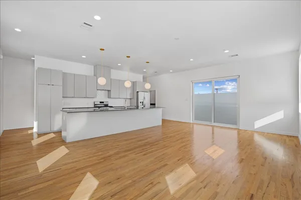 a view of kitchen with kitchen island and stainless steel appliances
