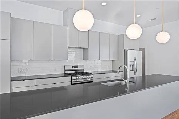 a kitchen with a sink cabinets and stainless steel appliances