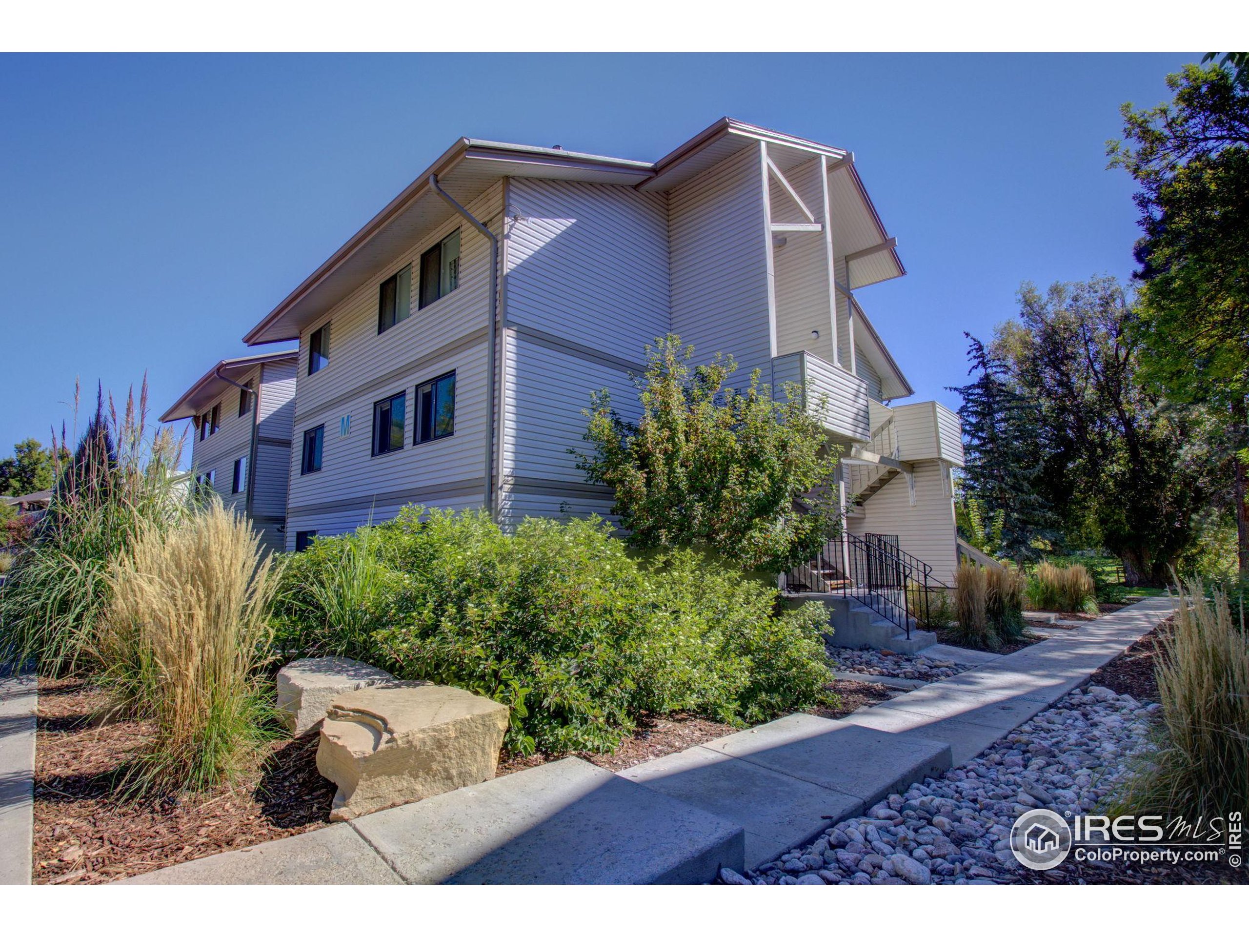 1705 Heatheridge Road, Unit M204 Fort Collins, CO 80526 - Photo 1 of 35 a front view of a house with garden